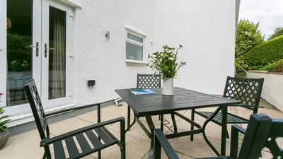 a black table and chairs on a patio at Swn y Mor in Harlech