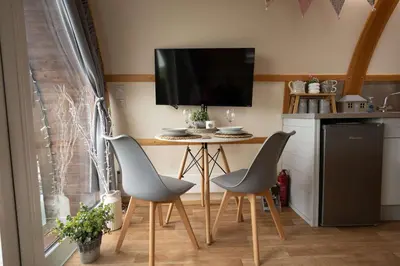 a kitchen with a small table with two chairs and a tv at Aberystwyth by Wigwam Holidays in Aberystwyth