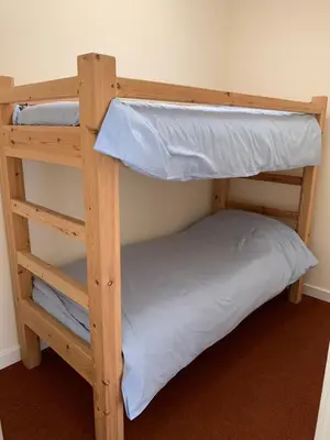 two bunk beds in a room with a pillow at River Wye Hostel in Hereford