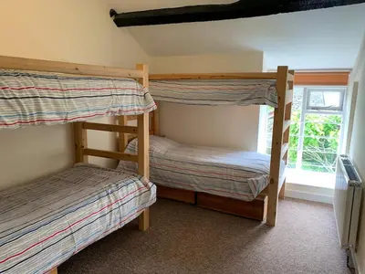 two bunk beds in a room with a window at River Wye Hostel in Hereford