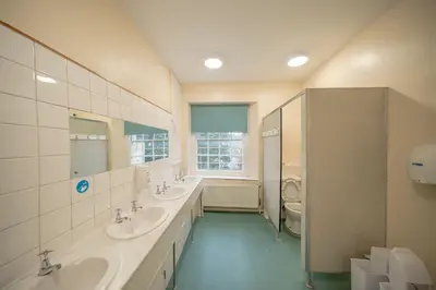 a bathroom with two sinks and two mirrors at River Wye Hostel in Hereford