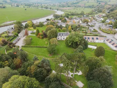 an aerial view of a park with trees and a river at River Wye Hostel in Hereford