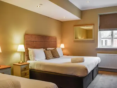 a bedroom with two beds and a mirror at Uk47787 - Flat 5E in Aberystwyth