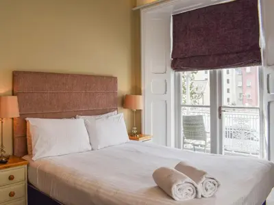 a bedroom with a bed with towels on it at Uk47786 - Flat 4E in Aberystwyth