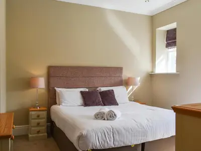 a bedroom with a bed with two towels on it at Uk47786 - Flat 4E in Aberystwyth