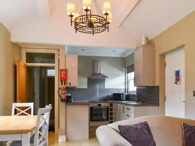 a kitchen with a table and a chandelier at Flat 3E - Uk47858 in Aberystwyth