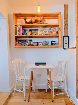 a table and two chairs in a room at Cosy Welsh Town Cottage in Brecon