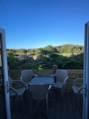 a blue table and chairs on a deck at Mountain View Brown lodge in Aberystwyth