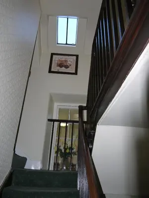 a stairway with a window and a picture on the wall at Ivy House B&B in Dolgellau