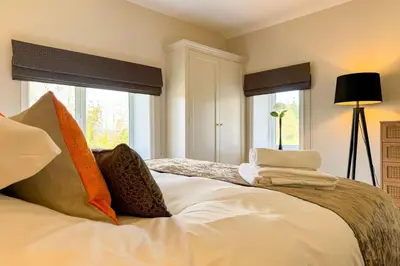 a bedroom with a bed with pillows on it at Marrington Lodge in Chirbury