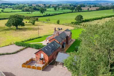 an aerial view of an old house in a field at The Annexe in Chirbury