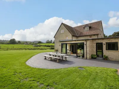 a house with a picnic table in front of it at Grove Farm in Church Stretton