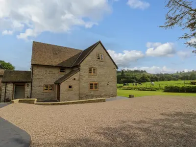 a large stone building with a roof at Grove Farm in Church Stretton