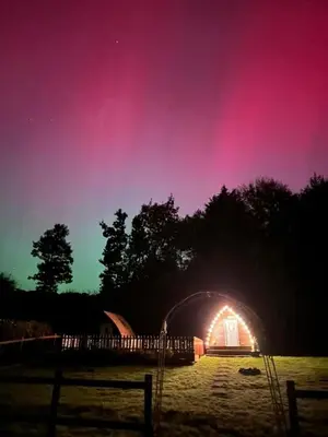 a lit up tent in a field at night at Glamping Life Retreat in Nantmel