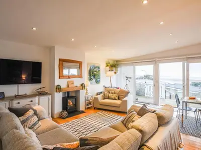 a living room with two couches and a television at The Glass House in Aberdyfi