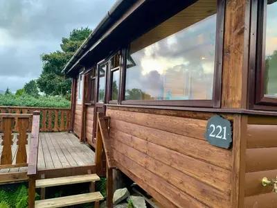 a wooden train car with a sign on it at Caban Marjie in Trawsfynydd
