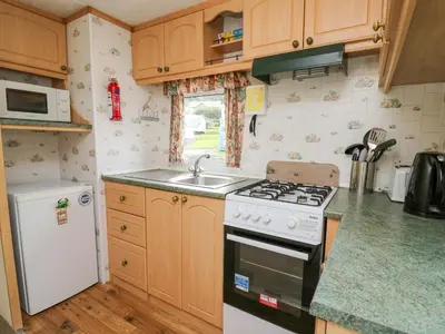 a kitchen with a stove and a sink at D12 Treetops in Aberystwyth