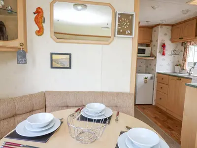 a kitchen with a table with white dishes on it at D12 Treetops in Aberystwyth