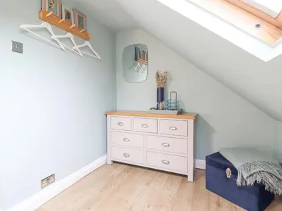 a bedroom with a white dresser in a attic at Tŷ Kinik in Llangollen