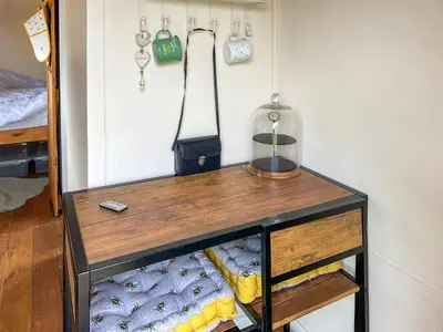 a table in a room with a bed and a bottle at Myfanwy in Ciliau-Aeron