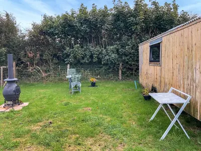 a backyard with a grill and a table and chairs at Myfanwy in Ciliau-Aeron