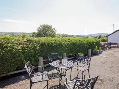 a table and chairs sitting on a patio at Bryn Bras in Corwen