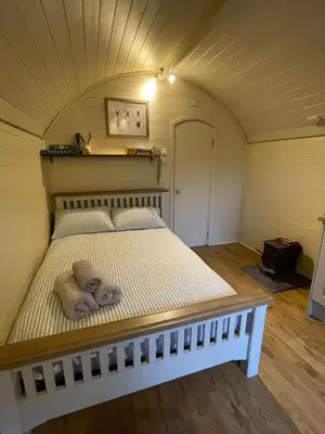 a bed in a small room with a ceiling at Damson Lodge in Hereford
