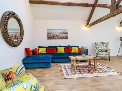 a living room with a blue couch and a table at The Granary in Montgomery