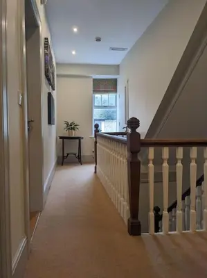 a hallway of a home with a staircase and a window at Cartref Guesthouse - Room 1 Ensuite in Aberdyfi