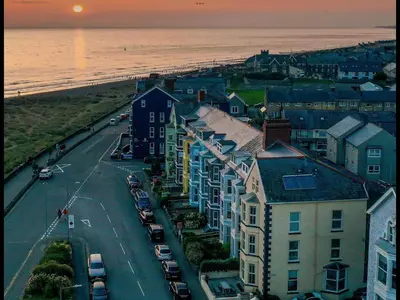 an aerial view of a street with houses and the ocean at Barmouth Beach Front Apartments in Barmouth