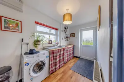 a kitchen with a washing machine and a sink at 3 Bed in Llanrhystud oc-m28913 in Llanrhystyd