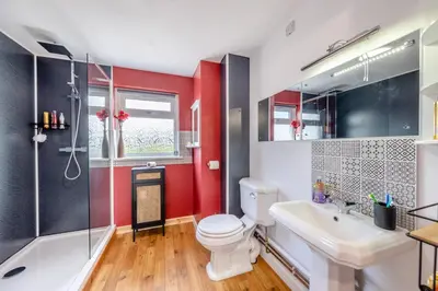 a bathroom with a toilet and a shower and a sink at 3 Bed in Llanrhystud oc-m28913 in Llanrhystyd