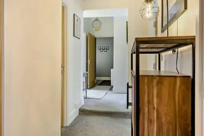 a hallway with a hallway leading to a room with at Beautiful Town Centre Apartment 110 Square Metre With Parking WEEKLY and MONTHLY Reduced Rates in Shrewsbury