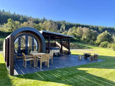 a gazebo with a table and chairs in the grass at Y Fedwen in Llanwddyn