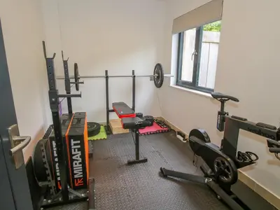 a fitness room with a gym with several machines at Timberdyne in Ludlow