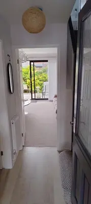 a hallway with a door leading to a room at Ludlow Mews Town House with Free parking in Ludlow