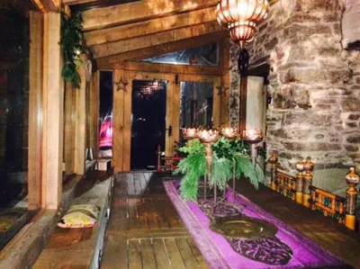 a lobby with a stone wall and a room with a table at Mellow Mountain Eco Retreat Wales Hot-Tub Sauna in Glyn-Ceiriog