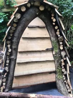 a house made out of wood and logs at Mellow Mountain Eco Retreat Wales Hot-Tub Sauna in Glyn-Ceiriog
