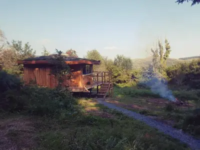 a cabin in the middle of a field at Magical Offgrid Roundhouse in Eryri in Machynlleth