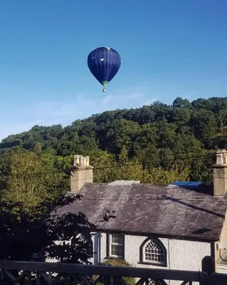 a hot air balloon flying over a house at Castle View chalet in Llangollen