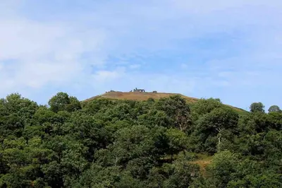 a hill with a house on top of it at Castle View chalet in Llangollen