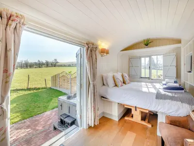 a bedroom with a bed and a large window at Sunflower - Uk42360 in Saint Harmon