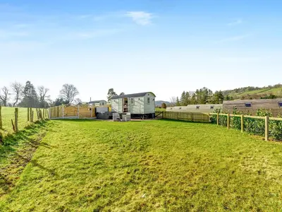 a large grassy field with an rv in the background at Sunflower - Uk42360 in Saint Harmon