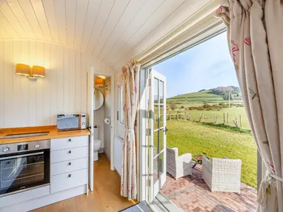 a kitchen with a view of the countryside from a caravan at Sunflower - Uk42360 in Saint Harmon