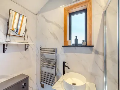 a white bathroom with a sink and a window at Tulip - Uk42363 in Saint Harmon
