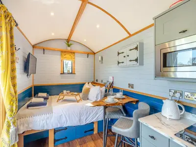 a room with a bed and a table and chairs at Tulip - Uk42363 in Saint Harmon