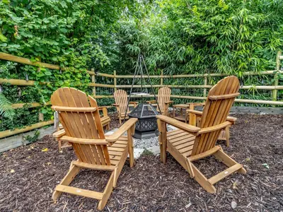 a group of chairs sitting around a fire pit at The Lodge Spa - Uk47837 in Church Pulverbatch