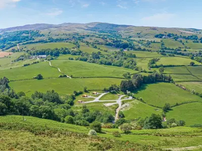 a view of green hills with a road in the middle at Glampio Trysor Merddwr-Ukc5826 in Llangwm
