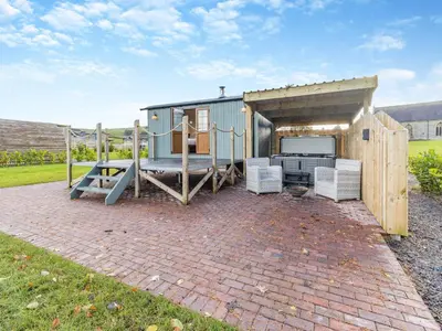 a tiny house with a playground in the backyard at Mayflower - Uk42359 in Saint Harmon