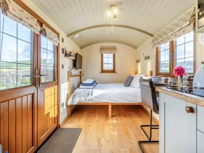 a bedroom with a bed and a desk in a room at Mayflower - Uk42359 in Saint Harmon